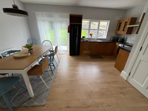 a kitchen and dining room with a table and chairs at 2 Cois Chnoic - Dingle holiday home in Dingle
