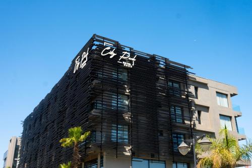 a building with a clock on the top of it at City Park Hôtel in Casablanca