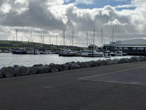 a group of boats docked in a marina with a building at 2 Cois Chnoic - Dingle holiday home in Dingle