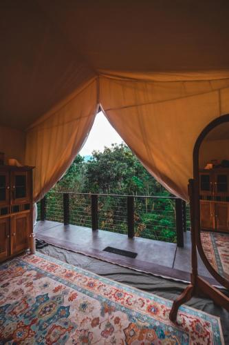 a view from a room with a bed and a balcony at Desa Eko in Munduk