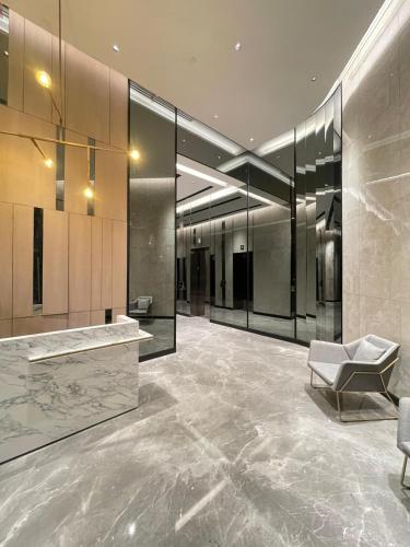a lobby with a counter and a chair in a building at TranquiLoft LuxLiving in Cilenggang