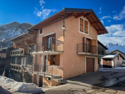 a house in the mountains with snow on the ground at Chalet spacieux avec vue magnifique in Saint-Marcel