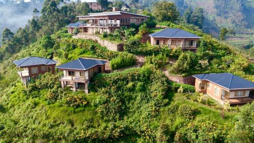 a group of houses on a hill withgrass at Burunga Gorilla Lodge in Kisoro