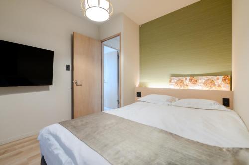 a bedroom with a bed and a flat screen tv at 楽途ホテル 東十条 in Tokyo