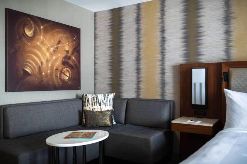 a hotel room with a couch and a bed at Kansas City Marriott Downtown in Kansas City