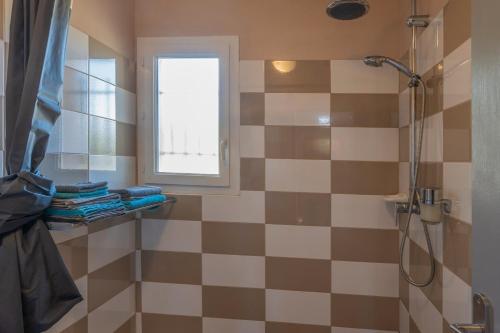 a bathroom with a shower and a window at Gîte Chêne ou Murier in Les Vans