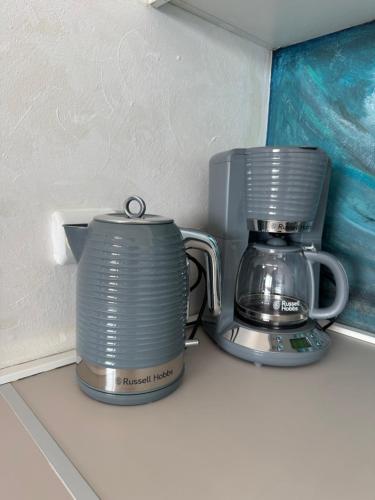 a slow cooker and a coffee maker sitting on a counter at Apartment „Blue“ in Mandre