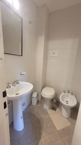 a white bathroom with a sink and a toilet at Beautiful 2 bedroom on the Cañitas Palermo border in Buenos Aires