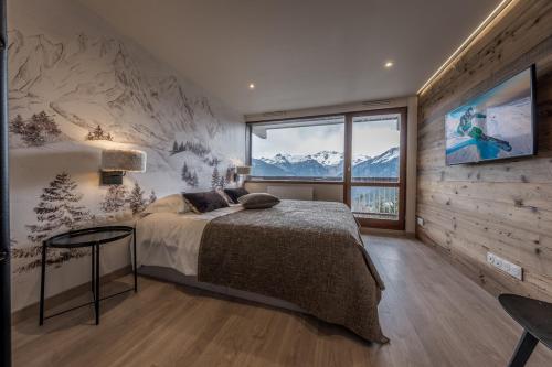 En eller flere senge i et værelse på Charmant duplex 2 chambres Courchevel 1550
