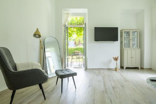 a living room with a chair and a table at Apartment Ortensia in Tremezzo