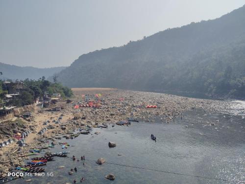 a group of people on a beach in the water at Meban camping shnongpdeng in Dawki