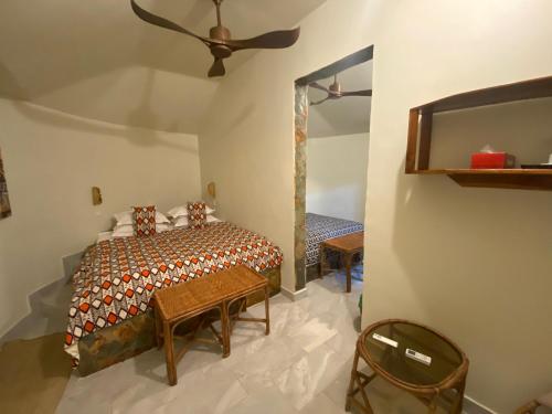 a bedroom with a bed and a ceiling fan at Oasis beach resort in Cape Coast