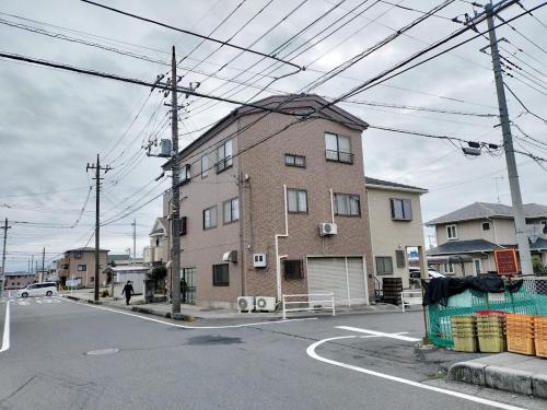a large brick building on the corner of a street at 65m2 Free parking Modern Japanese style Toys for kids Great sunlight Kids can relax in Kasukabe
