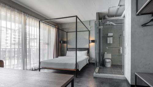 Кровать или кровати в номере The Ex Capital Hotel Bangkok by Dancenter