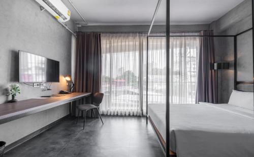 Кровать или кровати в номере The Ex Capital Hotel Bangkok by Dancenter