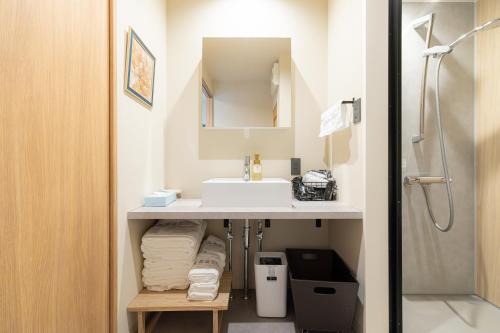 a bathroom with a sink and a mirror at 楽途ホテル 東十条 in Tokyo