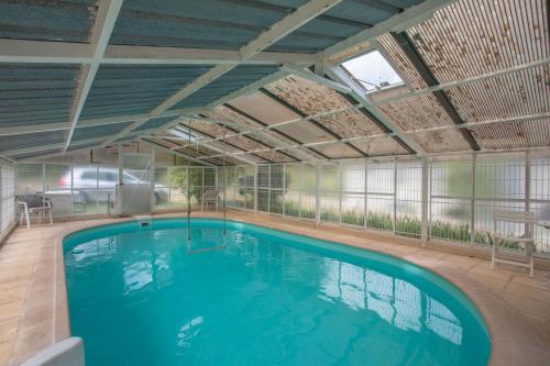 a large indoor swimming pool in a building at Villa la Myreclose in Saint-Auban