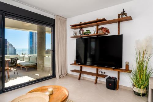 a living room with a large flat screen tv at Saeta 13B Calpe in Calpe
