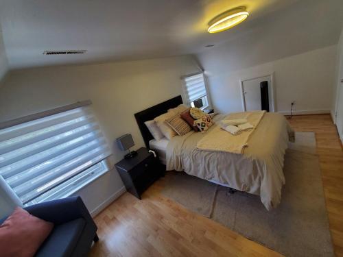 a bedroom with a large bed and a window at Beautiful Newly Renovated House in Roberval