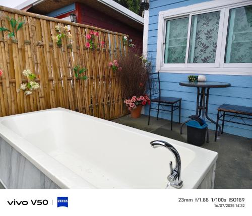 a kitchen sink in front of a house with a fence at พูลวิลล่าminiบ้านสวนเกดกนกเขาค้อ in Phetchabun