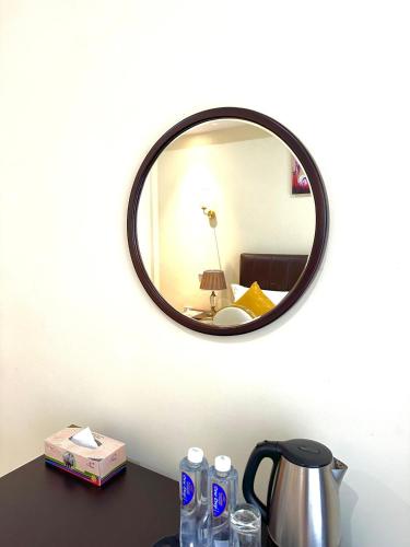 a mirror on a wall above a table at KIjichi gateway Hotel in Dar es Salaam