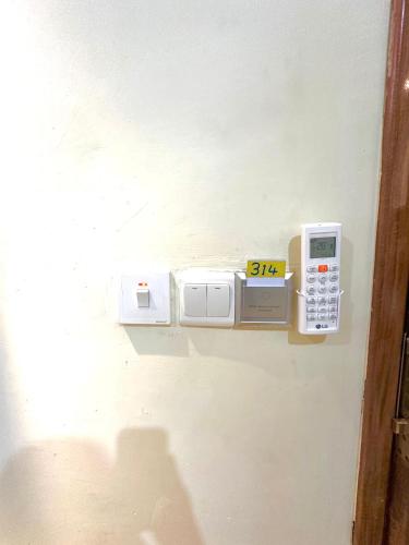 a wall with several appliances on a wall at KIjichi gateway Hotel in Dar es Salaam