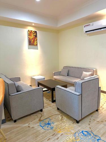 a living room with two couches and a table at KIjichi gateway Hotel in Dar es Salaam