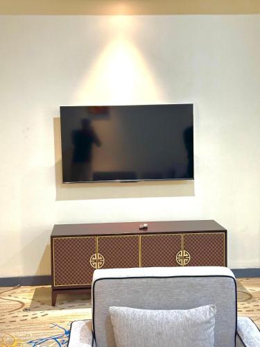 a flat screen tv on a wall in a living room at KIjichi gateway Hotel in Dar es Salaam
