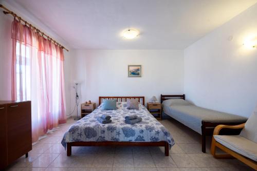 a bedroom with a bed and a couch at Apartments Soni in Postira