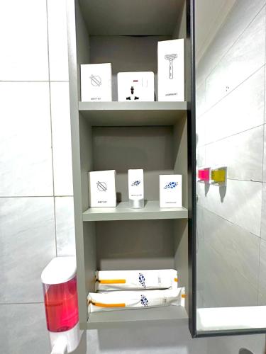 a shelf in a bathroom with white towels on it at KIjichi gateway Hotel in Dar es Salaam