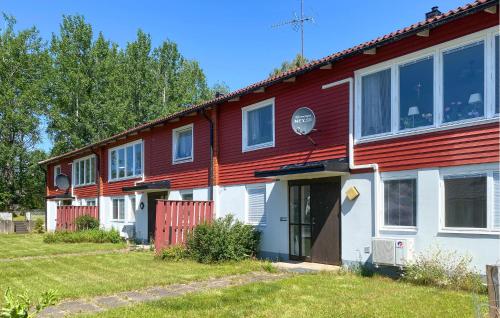 a red and white house with a yard at Amazing Apartment In Pauliström With Wifi in Pauliström