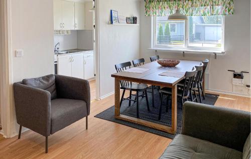 a kitchen and dining room with a table and chairs at Amazing Apartment In Pauliström With Wifi in Pauliström