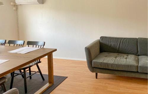 a living room with a couch and a table at Amazing Apartment In Pauliström With Wifi in Pauliström