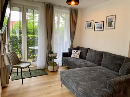 a living room with a couch and a chair at Möwennest in Nienhagen