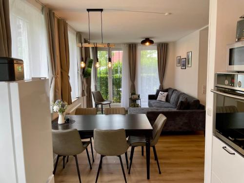 a kitchen and living room with a table and chairs at Möwennest in Nienhagen