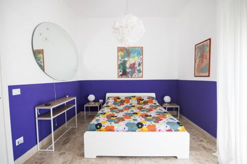 a bedroom with a bed and a table and a mirror at Al ventitré in Reggio Calabria