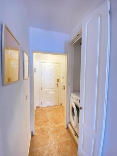 a hallway with a white door and a washing machine at Costa Adeje Dream View - 2 Bedroom Apartment with Terrace in Adeje