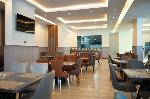 Un restaurante con mesas y sillas y un bar. en Crescent International Hotel, en Addis Ababa