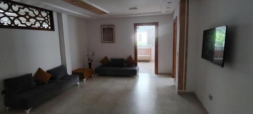 a living room with two couches and a window at تونس سوسة شط مريم in Akouda