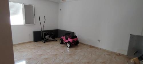 a room with a pink toy car on the floor at تونس سوسة شط مريم in Akouda