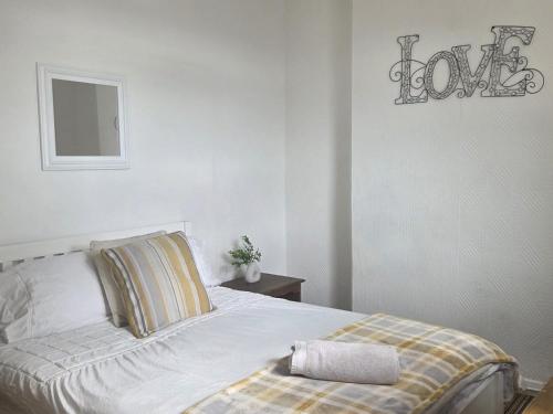 a bedroom with a bed with a towel on it at 52 - room 1 - city views in Swansea