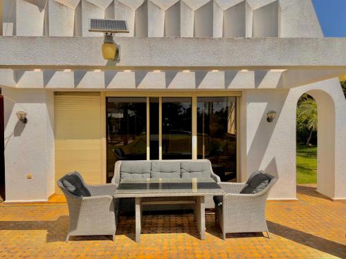 a patio with a table and chairs in front of a building at villa dar esalam in Rabat