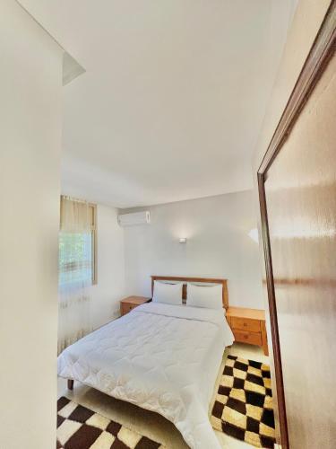 a bedroom with a bed and a checkered floor at villa dar esalam in Rabat