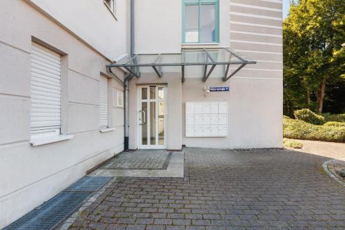 a white building with a door and a window at Schweizer Grenze in Waldshut-Tiengen
