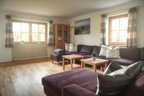 a living room with a couch and a table at Ferienhaus Am Riedl in Siegsdorf