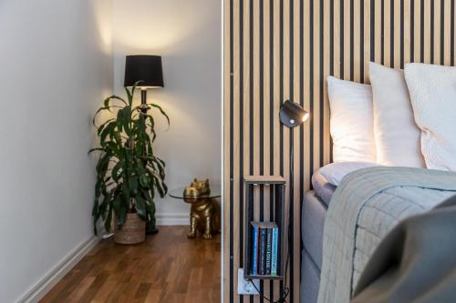 a bedroom with a bed and a potted plant at Annavälla gårdshus in Skurup