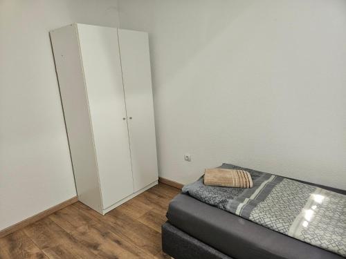 a small bedroom with a bed and a closet at Rooftop Retreat Heilbronn in Heilbronn
