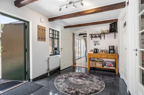 a hallway with a door and a rug on the floor at Annavälla gårdshus in Skurup