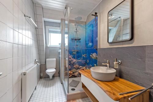 a bathroom with a sink and a toilet and a shower at Casa Doro in Donaueschingen