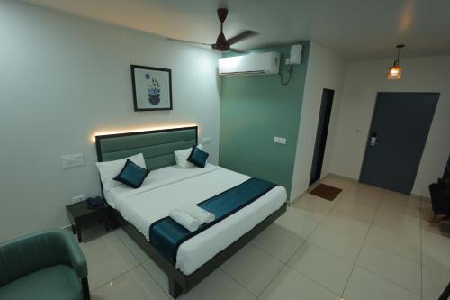 a bedroom with a large bed and a couch at The Lotus Park in Srikalahasti